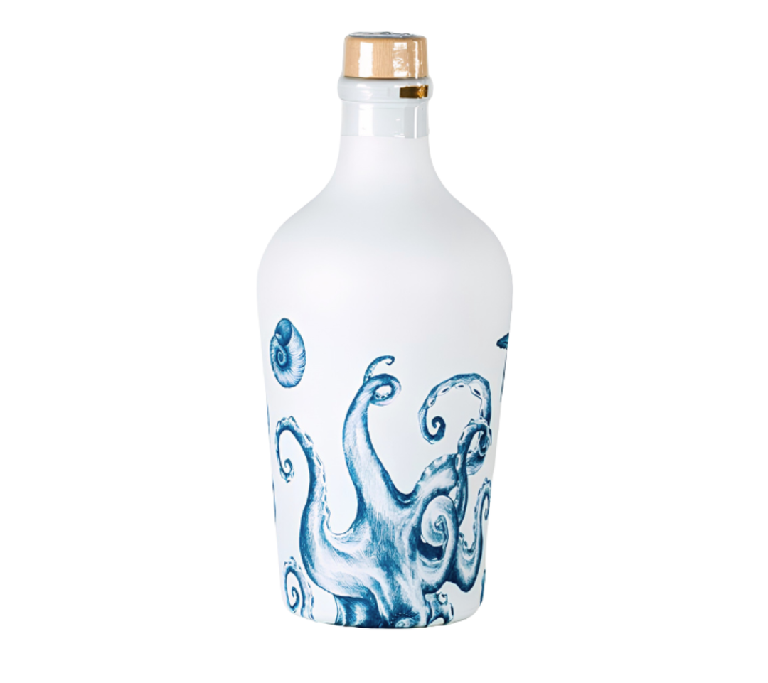 A frosted glass bottle with a white octopus tentacle print in blue, sealed with a gold foil cap, set against a plain white background.