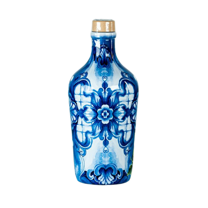 A decorative ceramic bottle with a blue and white floral pattern, featuring a gold-toned cap, isolated on a white background.