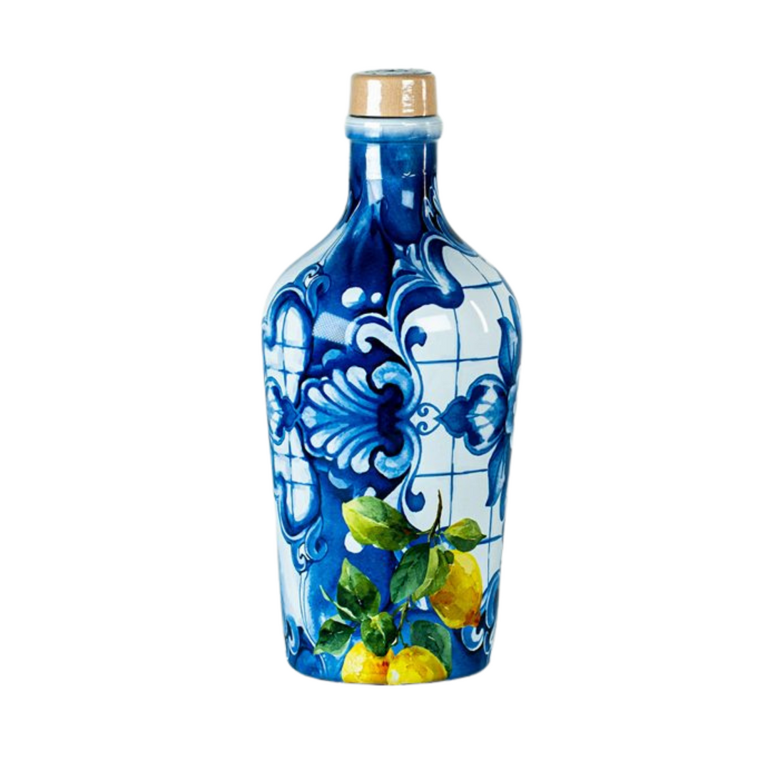 A decorative ceramic bottle with a blue and white Portuguese tile pattern and painted lemons, topped with a gold-colored cap, isolated on a white background.