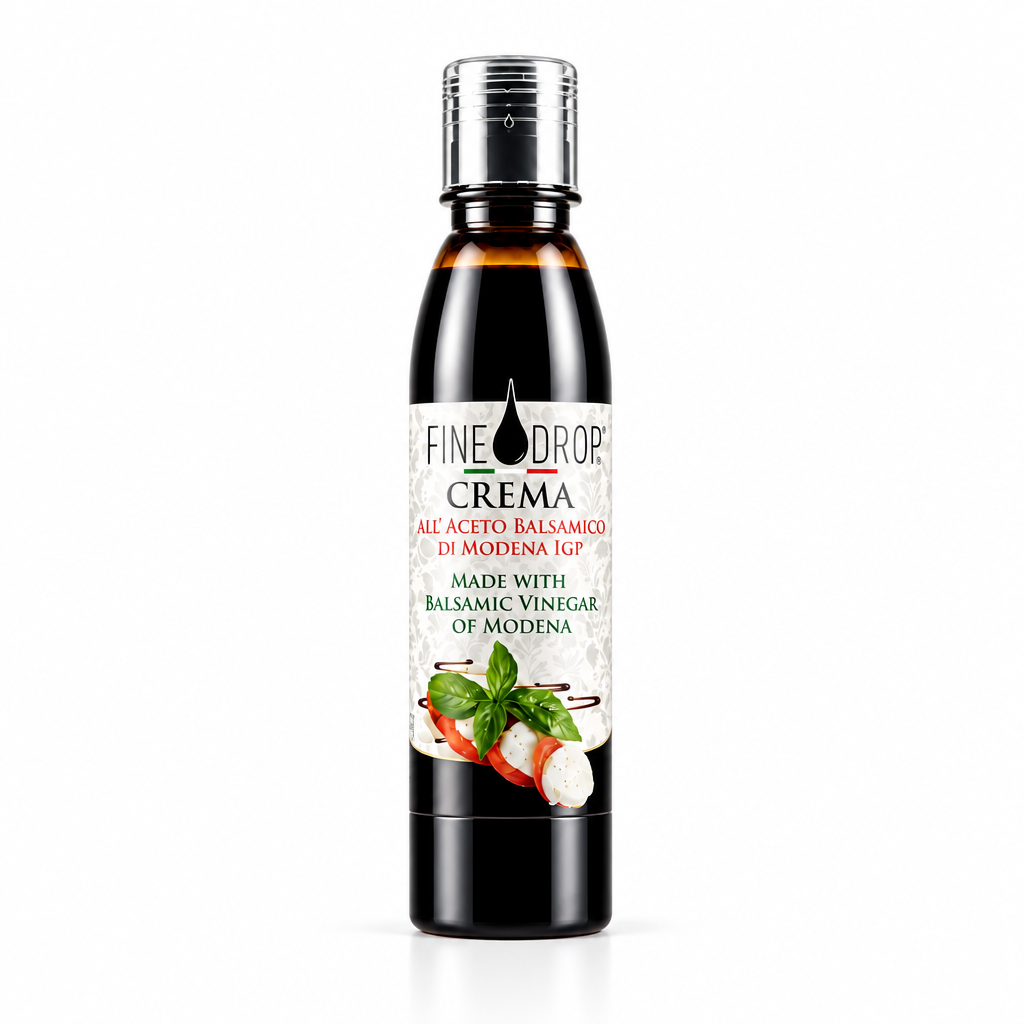 A bottle of Fine Drop Crema Balsamic Vinegar of Modena, featuring a dark glass bottle with a silver cap and a white label with red and green text and food illustrations, set against a plain white background.