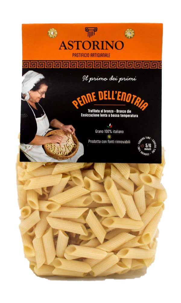 A package of Astorino Penne Dell'Enotria dried pasta, showing the orange and black branded label above a clear window displaying the light beige penne pasta inside.