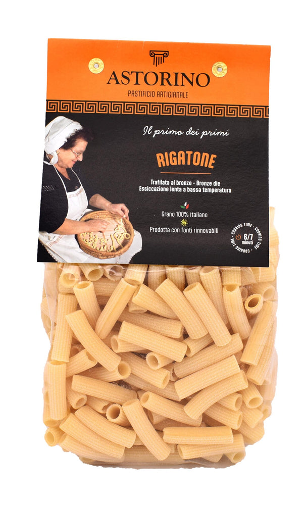 A package of Astorino Rigatone pasta, showing the beige pasta inside a clear bag with an orange and black label, isolated on a white background.