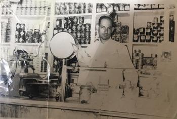 Emilio Sergio standing behind the counter of the original store