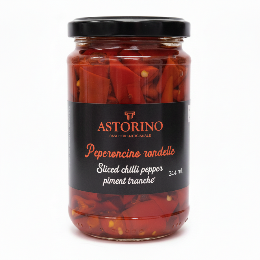 A glass jar of Astorino sliced chili pepper in oil, featuring a black label with red and white text and a black screw-on lid, set against a plain white background.