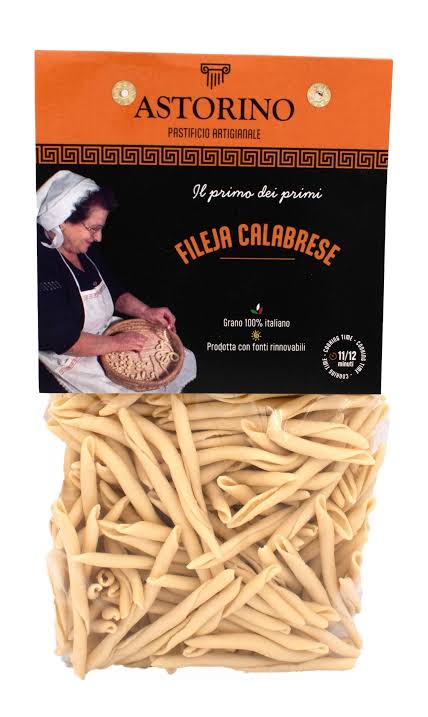 A package of Astorino Filaia Calabrese pasta, showing the clear lower half filled with light tan penne pasta and an orange and black branded header card above.