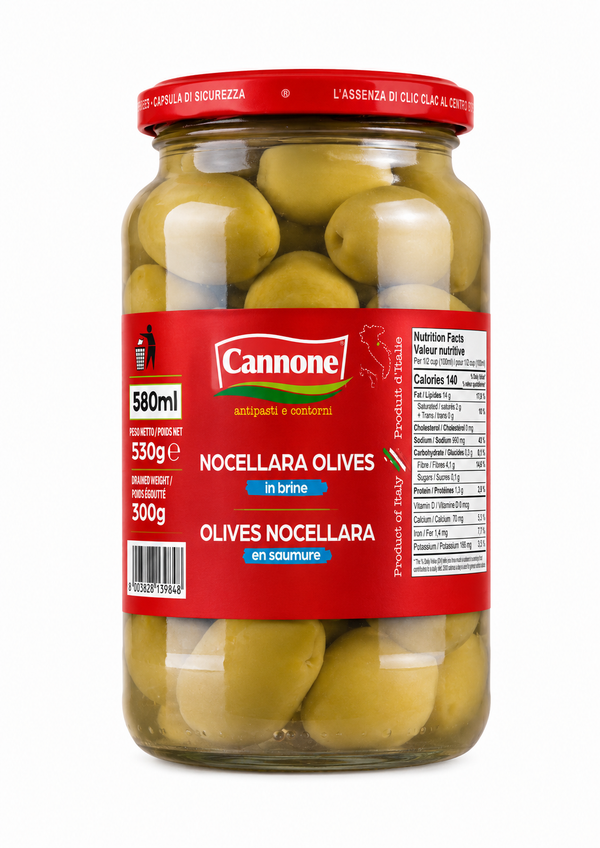 A glass jar of Cannone Nocellara Olives in brine, featuring green olives inside and a red label with white and green text, set against a plain white background.