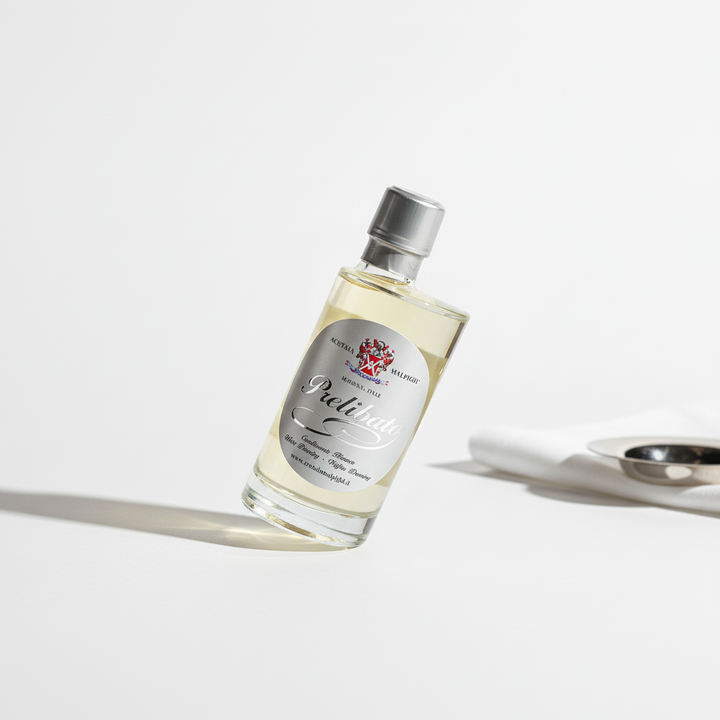 A clear glass bottle of acetaia malpighi White Dressing with a silver cap